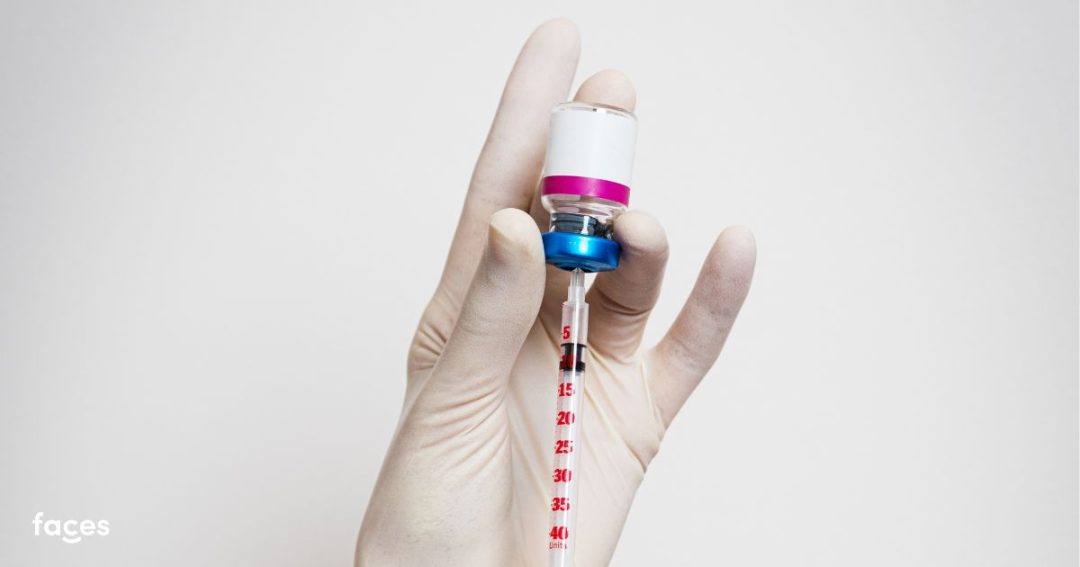 botox-like vial being inserted with an injection to extract botox formula