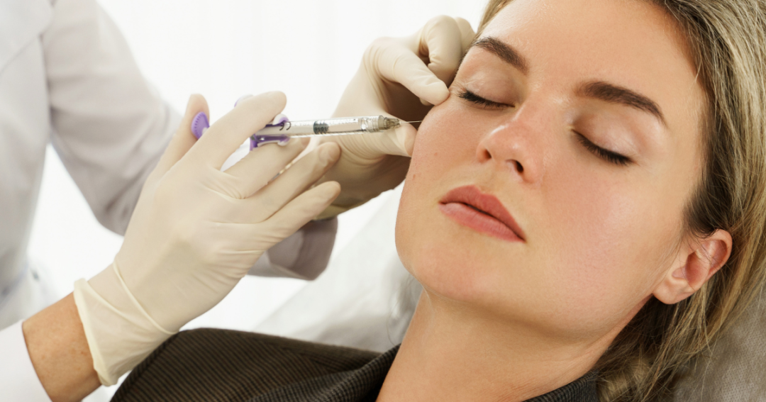 Revolax filler being injected into the lips by a practitioner in a clinical setting.