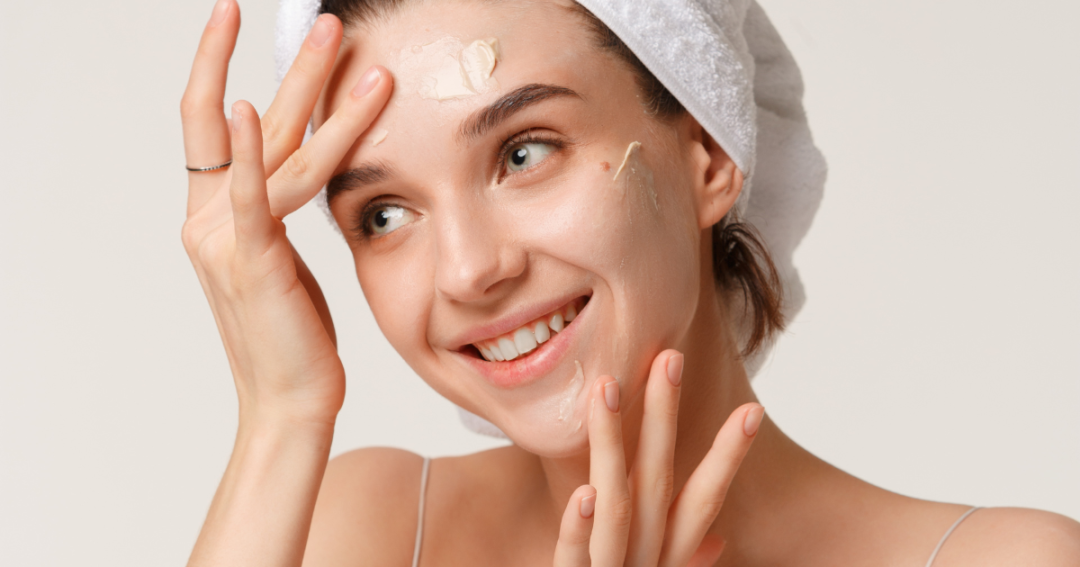 Close-up of a woman gently massaging moisturiser into her skin as part of her daily skincare routine.