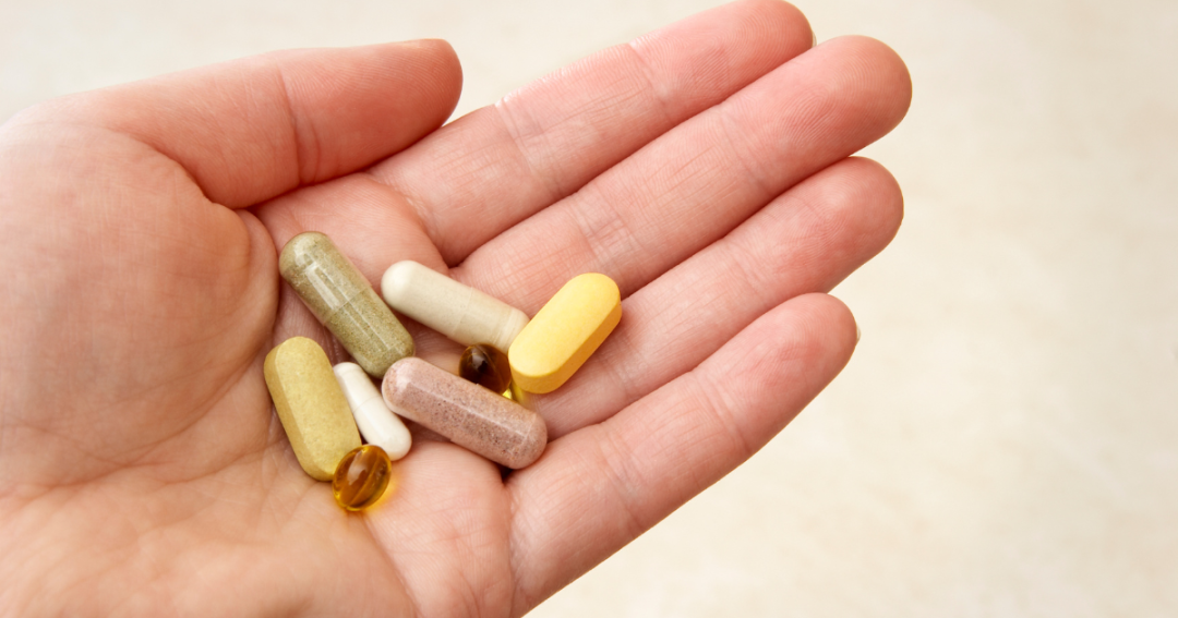 Collagen Supplements: What You Need to Know 1 A client holding several collagen supplement capsules in their hand, emphasizing health and wellness.