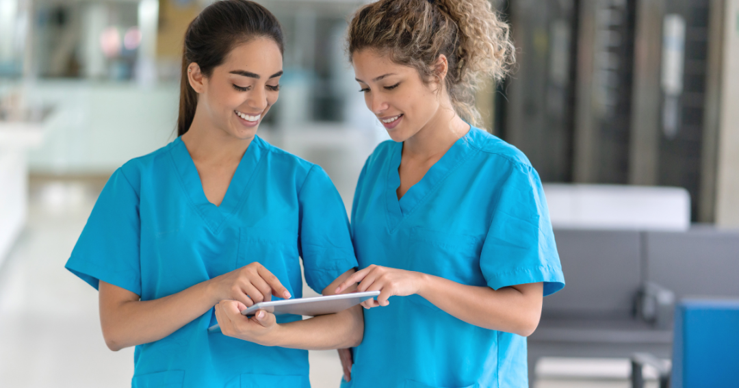 Medical professional in a clinic using a tablet with patient management software to track treatments and appointments.