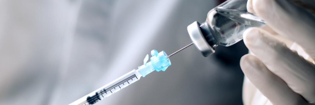 Practitioner reconstituting botulinum toxin by drawing bacteriostatic saline into the vial.