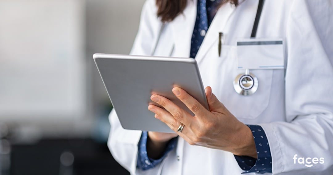Nurse using a tablet to manage patient records in a clinic, reviewing medical notes with secure healthcare software.