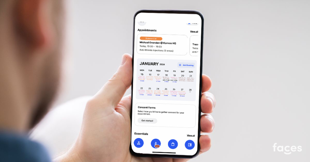 A practitioner using the Faces app on a phone to check a client’s appointment.