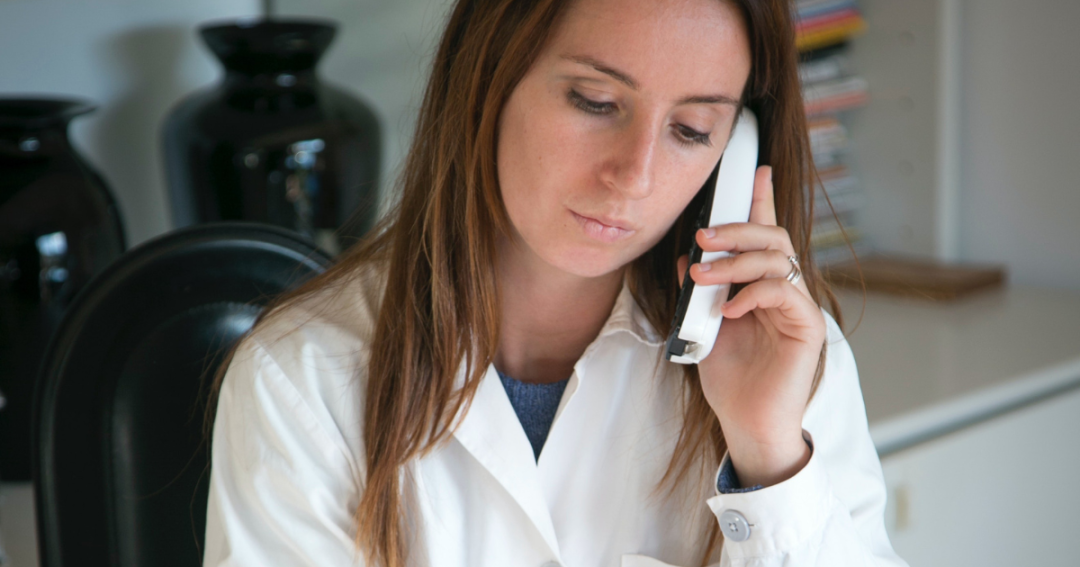Practitioner calling a client after a no-show appointment at the clinic.