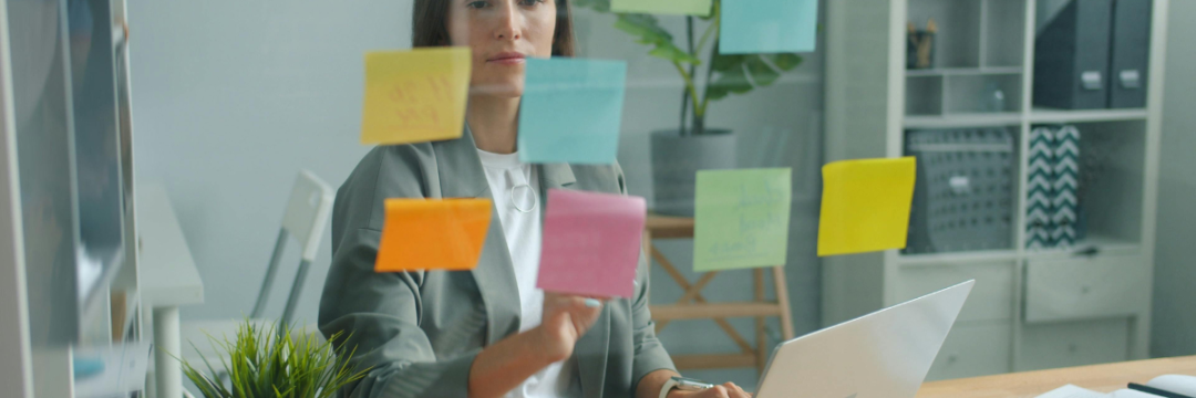 A marketing professional reviews social media posts on a laptop, evaluating engagement and content performance.