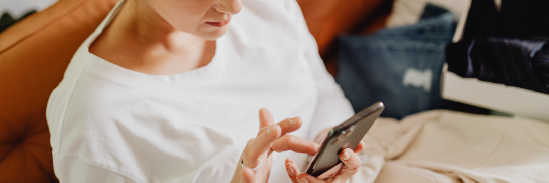 Client signing a digital aesthetic consent form on a smartphone before a clinic appointment