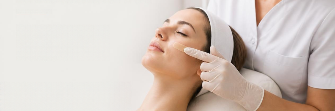 Pigmanorm Cream: Why Most Melasma Patients Use It Wrong 2 Practitioner applying a thin layer of pigmentation cream to melasma on the cheek, with tinted SPF 50 ready for daytime protection
