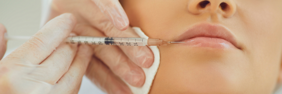 Practitioner testing capillary refill on a client's lower lip in a clinic.